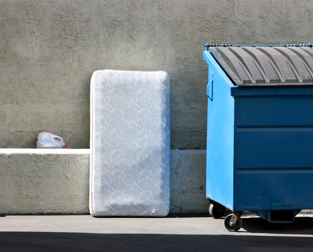 Mattress Next to Recycling Bin